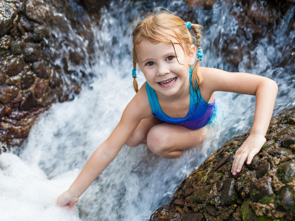 Girl Playing in waterfall